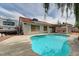 Backyard pool with tanning ledge surrounded by a concrete deck, creating a relaxing outdoor retreat at 1523 Silver Point Ave, Las Vegas, NV 89123