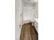 Bathroom featuring a shower-tub combo with wood-look flooring and white cabinets at 1832 Yellow Rose St, Las Vegas, NV 89108