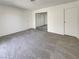 Bedroom featuring neutral carpet, white walls, and a mirrored closet at 1832 Yellow Rose St, Las Vegas, NV 89108
