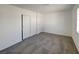 This bedroom features neutral carpeting, white walls, and a closet for storage solutions at 1832 Yellow Rose St, Las Vegas, NV 89108