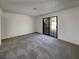 Bedroom featuring neutral carpet, a sliding glass door leading to the backyard at 1832 Yellow Rose St, Las Vegas, NV 89108