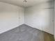 Bedroom with gray carpet, closet, and natural light at 1832 Yellow Rose St, Las Vegas, NV 89108