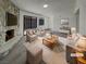 Bright living room with stone fireplace, plush seating, and sliding glass doors at 1832 Yellow Rose St, Las Vegas, NV 89108