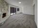 Spacious living room with neutral carpeting and a stone fireplace at 1832 Yellow Rose St, Las Vegas, NV 89108