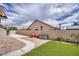Large backyard featuring a brick paver patio, an area of synthetic grass, and perimeter block wall at 1845 Candle Bright Dr, Henderson, NV 89074