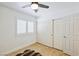 Bedroom with light wood floors, shutters on window, and ceiling fan at 1845 Candle Bright Dr, Henderson, NV 89074