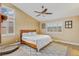 Well-lit bedroom with vaulted ceilings, plantation shutters, a wood bed frame, and wood-look floors at 1845 Candle Bright Dr, Henderson, NV 89074