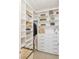 Walk-in closet has custom shelving and drawers, with space for clothes and accessories at 1845 Candle Bright Dr, Henderson, NV 89074