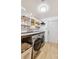 The laundry room features a front load washer and dryer, ample counter space, and shelving for storage at 1845 Candle Bright Dr, Henderson, NV 89074