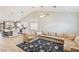 Bright open-concept living room with vaulted ceilings, tile floors, and a large sectional sofa at 1845 Candle Bright Dr, Henderson, NV 89074