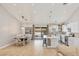 Open-concept living space with dining area, white kitchen, and sliding glass door access to backyard at 1845 Candle Bright Dr, Henderson, NV 89074