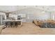Bright and open living space with kitchen island, tile floors, and a comfortable sectional sofa at 1845 Candle Bright Dr, Henderson, NV 89074