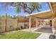Covered patio includes outdoor lighting, brick flooring, garden beds, and is perfect for entertaining at 1845 Candle Bright Dr, Henderson, NV 89074