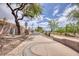 Concrete walkway through the community with mature trees and a dog station at 1845 Candle Bright Dr, Henderson, NV 89074