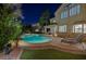 Stunning backyard with a pool, spa, lounge chairs, and lush landscaping at 1921 Spyglass Dr, Henderson, NV 89074