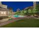 Inviting backyard features a pool, spa, lush landscaping, and patio space at 1921 Spyglass Dr, Henderson, NV 89074