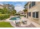 Relaxing backyard oasis with a pool, spa, lounge area, and well-manicured landscaping at 1921 Spyglass Dr, Henderson, NV 89074