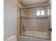 This bathroom features a shower-tub combo with glass doors and tile at 1921 Spyglass Dr, Henderson, NV 89074