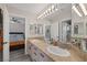 This bathroom features a double vanity with a large mirror and views into the bedroom and shower at 1921 Spyglass Dr, Henderson, NV 89074