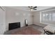 Bright bedroom features a ceiling fan, modern decor, and a window with plantation shutters at 1921 Spyglass Dr, Henderson, NV 89074