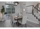 Bright dining room with slider to backyard, with a wooden table, and modern chandelier at 1921 Spyglass Dr, Henderson, NV 89074