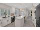 Bright kitchen showcasing white cabinets, quartz countertops, an island, and natural light from bay window at 1921 Spyglass Dr, Henderson, NV 89074
