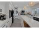 Open concept kitchen featuring white cabinets, quartz countertops, and stainless steel appliances at 1921 Spyglass Dr, Henderson, NV 89074