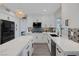 Well-lit kitchen showcasing white cabinets, mosaic backsplash, stainless steel appliances and island with countertops at 1921 Spyglass Dr, Henderson, NV 89074