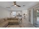Inviting living room boasts a ceiling fan, neutral tones, and seamless access to the kitchen and outdoor spaces at 1921 Spyglass Dr, Henderson, NV 89074