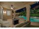 Inviting covered patio with seating, a fire pit, and a view of the backyard pool at 1921 Spyglass Dr, Henderson, NV 89074