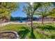 Community playground featuring a colorful jungle gym, mature shade trees, and grassy play area at 1921 Spyglass Dr, Henderson, NV 89074