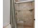 Walk-in shower showcasing elegant tile work, a built-in corner shelf, and a sleek glass enclosure at 1921 Spyglass Dr, Henderson, NV 89074