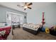 Comfortable bedroom featuring a ceiling fan and large window, offering a cozy and well-lit space at 1951 Jim Haworth Ct, Logandale, NV 89021