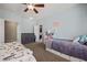 Bedroom with carpet, ceiling fan, large window, and access to closet, offering a cozy and functional space at 1951 Jim Haworth Ct, Logandale, NV 89021
