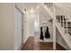 Hallway featuring staircase, coat rack with access to a full bathroom at 1951 Jim Haworth Ct, Logandale, NV 89021