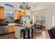 Bright kitchen with stainless steel appliances, wood cabinets, large sink, and eat in dining area at 1951 Jim Haworth Ct, Logandale, NV 89021
