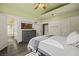 The primary bedroom boasts an arch window, ceiling fan and en-suite bathroom at 1951 Jim Haworth Ct, Logandale, NV 89021