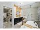 Elegant bathroom with a walk-in closet, dual vanity, luxurious tub, and a glass enclosed shower at 211 Kokopelli Ct, Henderson, NV 89074