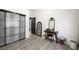 Bedroom area with a vanity, sliding closet door, and modern gray wood-look flooring at 211 Kokopelli Ct, Henderson, NV 89074