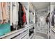 Organized walk-in closet with ample shelving, drawers, and stylish floral wallpaper at 211 Kokopelli Ct, Henderson, NV 89074