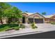 Charming single-story home featuring a well-manicured lawn and a three-car garage at 211 Kokopelli Ct, Henderson, NV 89074