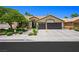 Charming single-story home with a well-manicured lawn and a spacious two-car garage at 211 Kokopelli Ct, Henderson, NV 89074