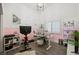 Bright office space with pink accent wall, white desk, shutters, and exercise equipment at 211 Kokopelli Ct, Henderson, NV 89074