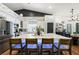 Bright, open kitchen with a large center island, modern appliances, and stylish barstool seating at 211 Kokopelli Ct, Henderson, NV 89074