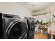 Well-organized laundry room featuring modern washer/dryer and ample shelving space at 211 Kokopelli Ct, Henderson, NV 89074