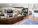 Open-concept living room with a built-in entertainment center, stylish decor, and ample natural light at 211 Kokopelli Ct, Henderson, NV 89074
