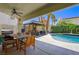 Inviting backyard oasis featuring a pool, outdoor dining area, and covered seating at 211 Kokopelli Ct, Henderson, NV 89074
