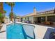 Gorgeous backyard featuring a sparkling pool, solar panels and outdoor dining area at 211 Kokopelli Ct, Henderson, NV 89074