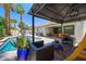 Stunning pool area with a covered patio, lounge chairs, and lush landscaping at 211 Kokopelli Ct, Henderson, NV 89074