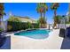 Beautiful pool area with palm trees, lush landscaping, and inviting lounge chairs at 211 Kokopelli Ct, Henderson, NV 89074